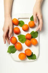 Rolgordijnen Fresh juicy apricots on a white background © Atlas