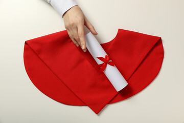 Cape of a graduate with a diploma, on a white background.