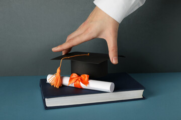 The hat of a university graduate, in his hands.