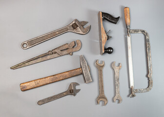 An old repair and construction tool on a gray background
