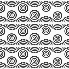 Seamless ethnic vector pattern. Ornamental pattern with circles and dotted wavy lines. Ethnic background. African style pattern. Black and white seamless tribal wavy background. For textile, fabric, w