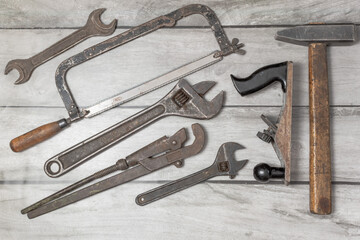 An old repair and construction tool on a wooden background