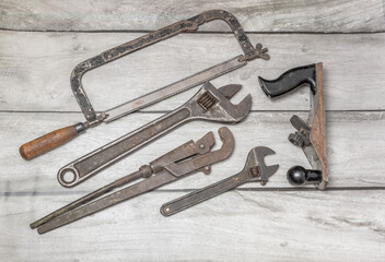 An old repair and construction tool on a wooden background