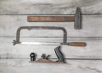 An old carpenter's tool on a wooden background