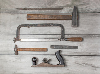 An old carpenter's tool on a wooden background
