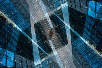 Fototapeta na wymiar symmetry and mirrored geometry pattern, reflected skyscrapers and modern buildings abstract background, lines and tunnel futuristic technology concept