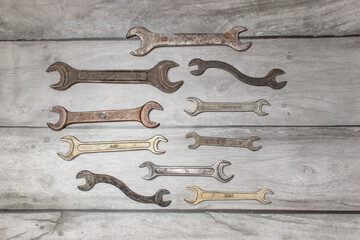 A set of wrenches on a wooden background