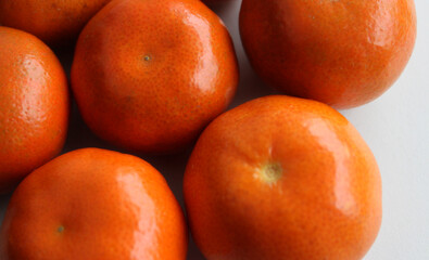 Closeup View Of Same Size Tangerine Fruits Laid Out Side By Side On A Flat Clean Surface
