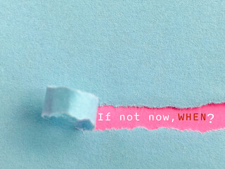 Inspirational and Motivational Concept - If not now, when. Text behind torn paper background. Stock photo.
