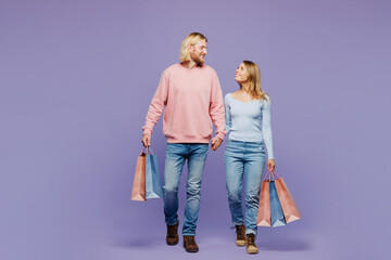 Full body happy young couple two friends family man woman wear pink blue casual clothes hold...