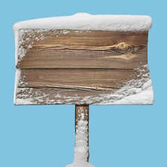 Wooden sign with snow isolated on blue