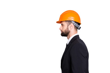 Profile side view half face portrait with copy space, empty place of  virile stylish investor with stubble in orange safety helmet, hardhat and black tux with tie, isolated on grey background