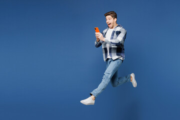 Full body excited happy young man he wearing shirt white t-shirt casual clothes jump high hold in...