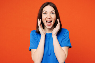 Young happy woman she wears blue t-shirt casual clothes scream sharing hot news about sales discount with hands near mouth isolated on plain red orange background studio portrait. Lifestyle concept.