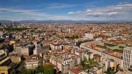 Milan cityscape against a background of blue sky, view from above in sunny weather