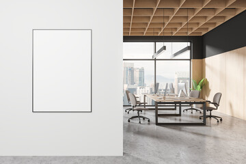 A modern office interior with a blank poster on the wall, wood elements, and city view through large windows. 3D Rendering - obrazy, fototapety, plakaty