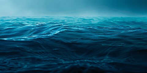 Calm blue ocean waves under a gradient sky, capturing the essence of tranquility and vastness.