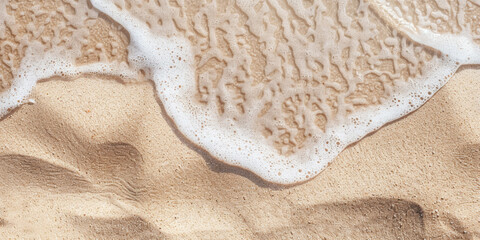 Shallow clear water with foamy bubbles flows around the sandy beach. A banner to illustrate a summer vacation