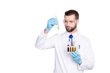 Portrait of busy concentrated scientist with stubble in white lab coat, gloves analysing, looking...