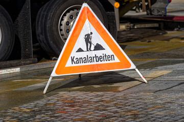 Close-up of triangle shaped mobile warning sign with text sewer works at Bürgenstock Resort Lake...