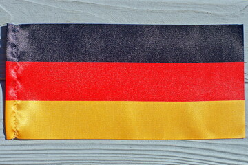 national european democratic flag of germany with black red and yellow stripes lies on a gray...