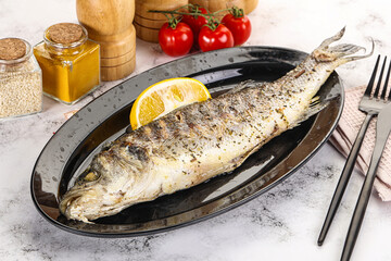 Grilled sea bass fish served lemon