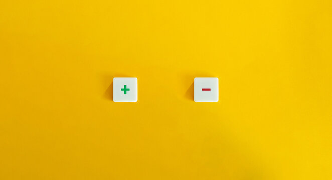 Green Plus Sign and Red Minus Sign. Concept of Pros and Cons, Positive and Negative Aspects, Strengths and Weaknesses. Text on Block Letter Tiles on Yellow Background. Minimalist Aesthetics.