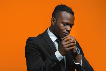 A focused businessman, checking his wristwatch with precision, set against a vibrant orange background.