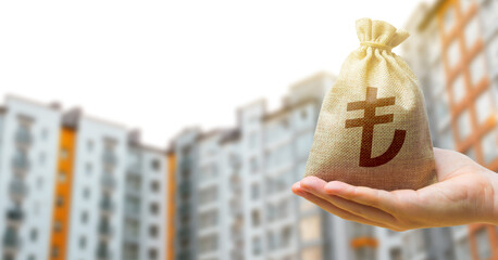 Turkish lira bag against the background of modern high-rise buildings. Investing in the purchase of...
