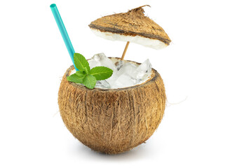 Exotic iced cocktail in coconut shell garnished with mint and straw isolated on white background. Summer vibes.