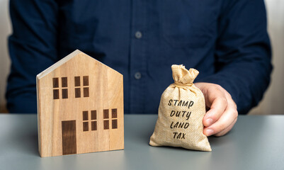 Stamp duty land tax SDLT concept. Taxes assessed during the transfer of real estate between two...