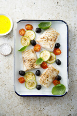 Roasted cod with olives, tomato and zucchini