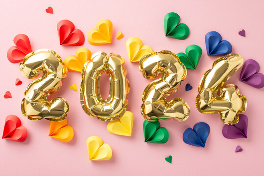 Diversity affirmation scene. Colorful hearts arranged in top view, signifying varied relationships. Pastel pink setting with golden balloon digits "2024", perfect for custom text or advertising