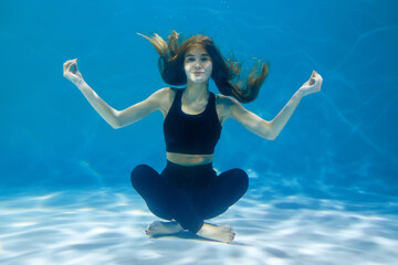 Woman doing exercise underwater