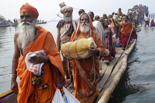 Pilgrims in traditional attire boarding a boat for a sacred journey, exemplifying faith and tradition