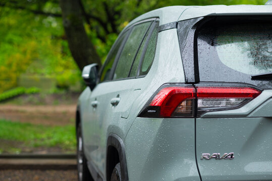 A portrait of the back of a green hybrid toyota rav4 car with the hybrid icon or logo. Kyiv, Ukraine - April 2024.