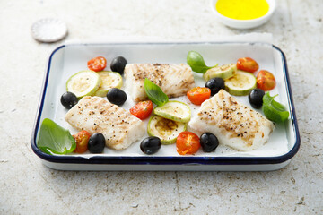 Roasted cod with olives, tomato and zucchini