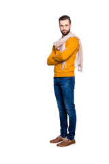 Full size fullbody portrait of stylish half turned stylist in sweater, jeans having scarf around...
