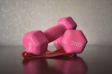 two dumbbells on a red background