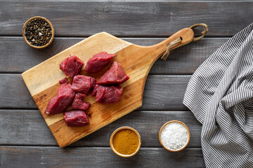 Beef meat on wooden board ready for cooking. Food background