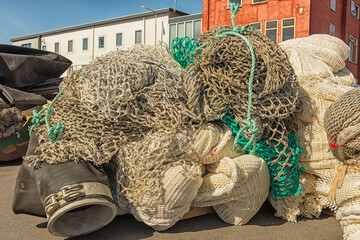 various types of professional fishing nets, including back nets are located outside on the harbor...