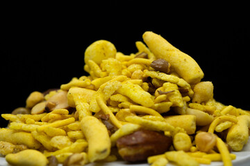 Indian Tea-time snacks like sev, chivda, farsan, mixture, boondi, bakarwadi etc served in white wooden box with cells. selective focus