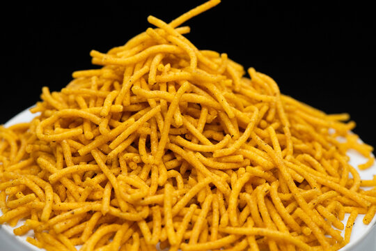 Alu bhujiya sev Indian snacks or namkeen in black background