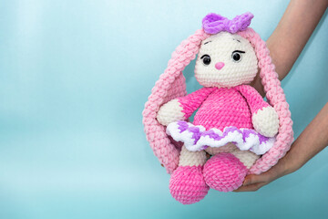Bunny. Long ears. Hobby crochet. Handmade. Amigurumi. Pink knitted rabbit. Soft toy.  Pink and blue...