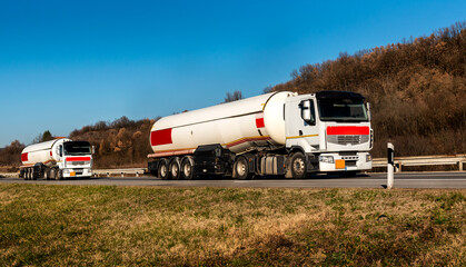 Gasoline tankers, Oil trailers, Tank trucks on highway close up on a Highway road with a beautiful...