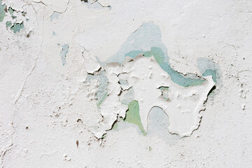 Showcasing the texture of a weathered wall with layers of peeling paint that reveal the passage of...
