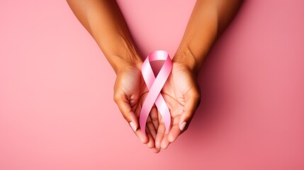 Pink ribbon on woman hands. For breast cancer awareness. October Pink day, world cancer day