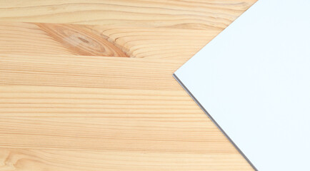 White blank paper on a wooden table, top view. A small stack of A4 sheets on the desktop, close-up. Blank paper, space for text, mockup