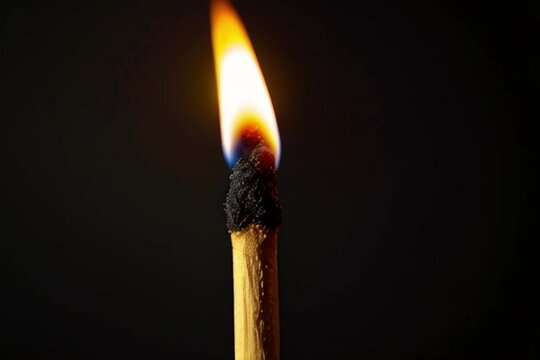 Single matchstick burning, a metaphor for climate change, urgency in environmental action, and energy consumption