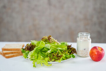 vegetable salad, whole wheat breads and granola yogurt on the table